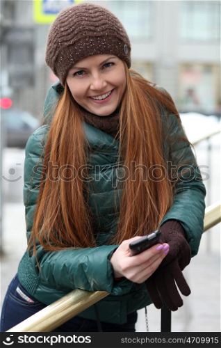 Happy young woman calling by phone