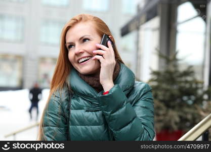 Happy young woman calling by phone