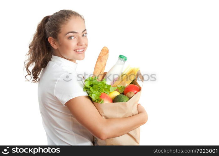 Happy Young Woman Carrying a Shopping Bag Full of Groceries at White Background