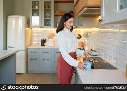 Happy young woman cooking coffee in cezve cup for breakfast on home kitchen. Happy young woman cooking coffee in cezve cup on kitchen