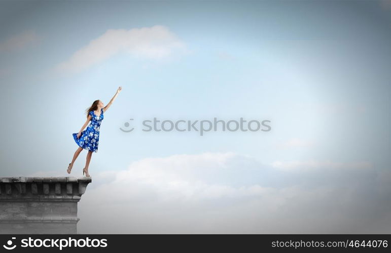 Happy young woman dreaming to fly in sky. Great day for freedom