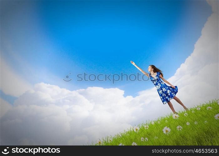 Happy young woman dreaming to fly in sky. Great day for freedom