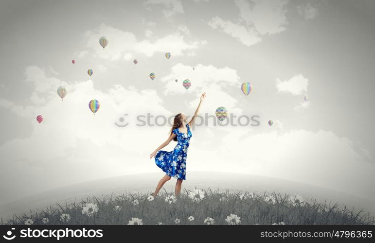 Happy young woman dreaming to fly in sky. Great day for freedom