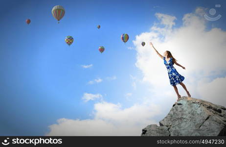 Happy young woman dreaming to fly in sky. Great day for freedom