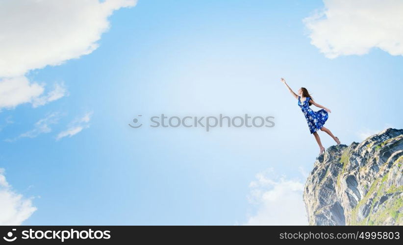 Happy young woman dreaming to fly in sky. Great day for freedom