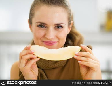 Happy young woman eating melon