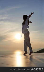 happy young woman enjoy sunset while dancing and enjoy music on headphones