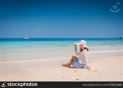 Happy young woman enjoying on beach relaxing summer at Thailand