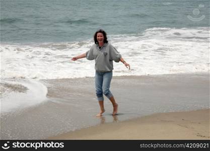 happy young woman enjoying the waves and the sea