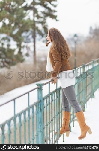 Happy young woman enjoying winter