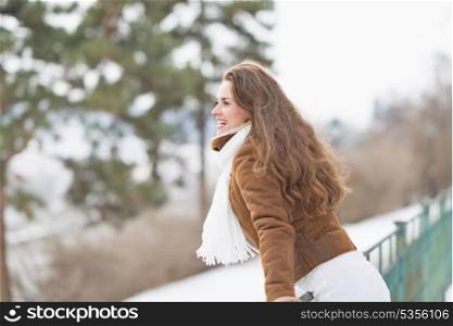Happy young woman enjoying winter outdoors