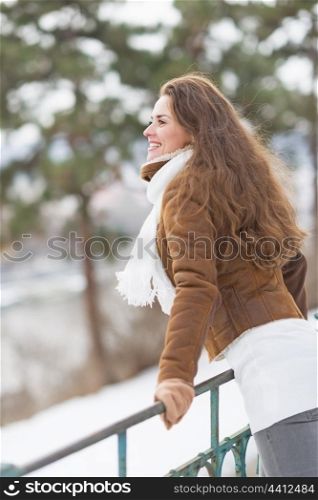Happy young woman enjoying winter park