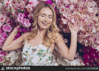 happy young woman feeling relaxed with branches orchid flowers