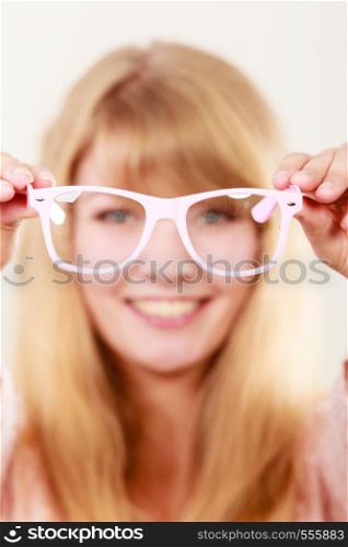 Happy young woman girl holding glasses. Smiling female in studio.
