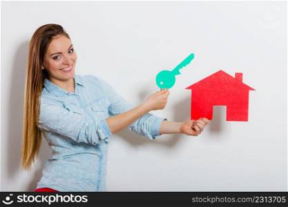 Happy young woman girl holding red paper house and key dreaming about new home house. Housing and real estate concept.. Woman and paper house. Housing real estate concept