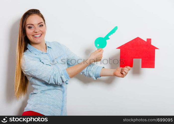 Happy young woman girl holding red paper house and key dreaming about new home house. Housing and real estate concept.. Woman and paper house. Housing real estate concept