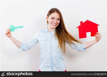 Happy young woman girl holding red paper house and key dreaming about≠w home house. Housing and real estate concept.. Woman and paper house. Housing real estate concept