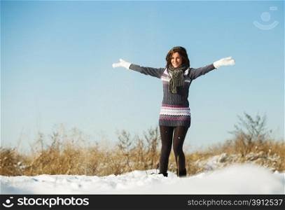 Happy young woman have fun and enjoy fresh snow at beautiful winter day