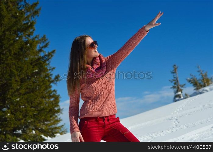 happy young woman having fun at winter nature landscape with fresh snow