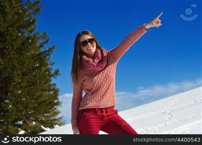 happy young woman having fun at winter nature landscape with fresh snow