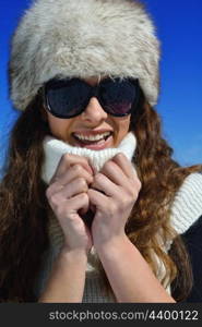 happy young woman having fun on winter vacation in beautiful nature landscape with fresh snow