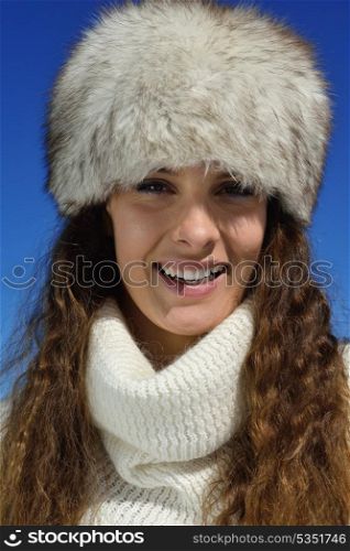 happy young woman having fun on winter vacation in beautiful nature landscape with fresh snow