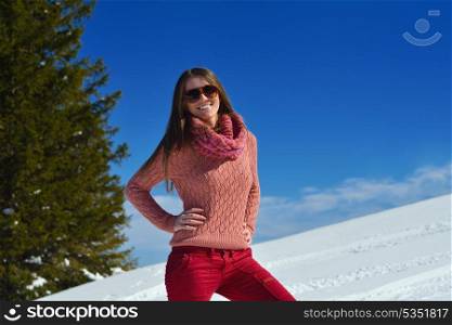 happy young woman having fun on winter vacation in beautiful nature landscape with fresh snow