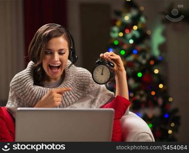 Happy young woman having video chat with family at New Year time