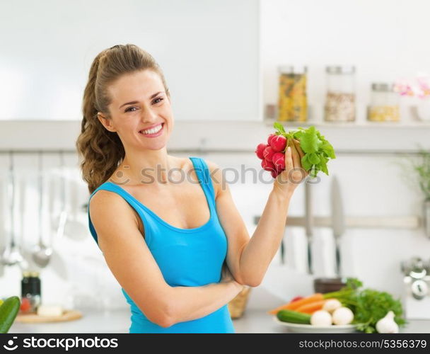 Happy young woman holding bunch of radishes