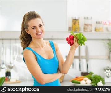 Happy young woman holding bunch of radishes