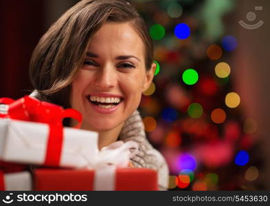 Happy young woman holding Christmas gift boxes