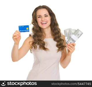 Happy young woman holding credit card and dollars packs