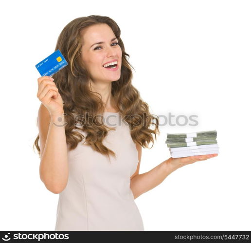 Happy young woman holding credit card and money packs