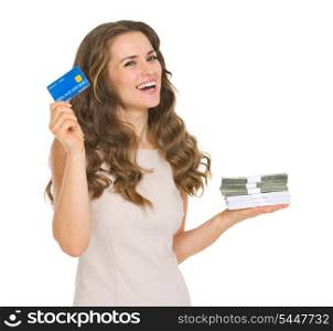 Happy young woman holding credit card and money packs