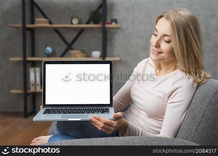 happy young woman holding looking her open laptop showing white display screen