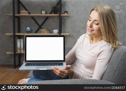 happy young woman holding looking her open laptop showing white display screen