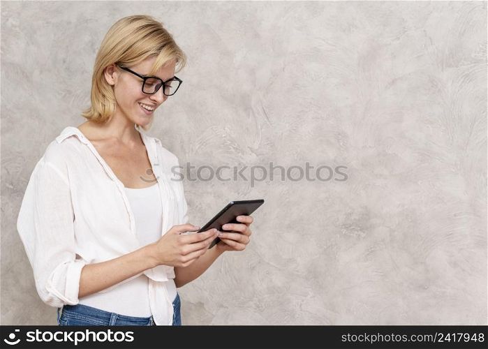 happy young woman holding tablet