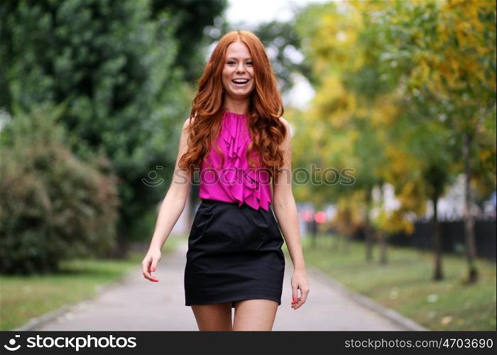 Happy young woman in autumn city