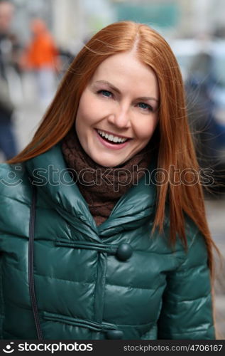 Happy young woman in autumn city