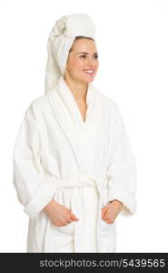 Happy young woman in bathrobe looking on copy space