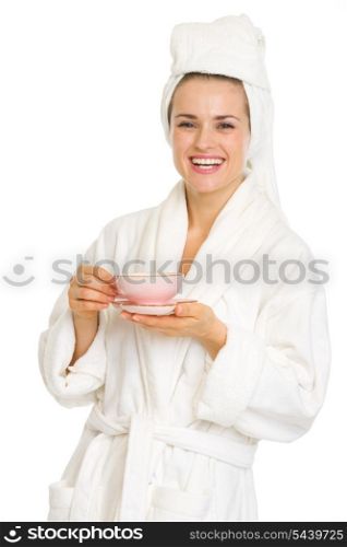 Happy young woman in bathrobe with cup of coffee