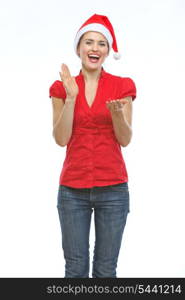 Happy young woman in Christmas hat clapping hands