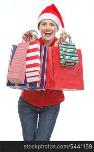 Happy young woman in Christmas hat with shopping bags
