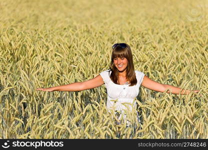 Happy young woman in corn field enjoy sunset