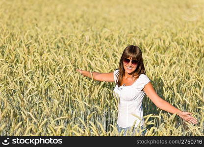 Happy young woman in corn field enjoy sunset