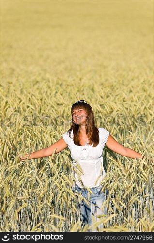 Happy young woman in corn field enjoy sunset on sunny day