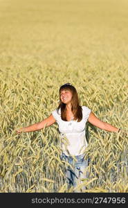 Happy young woman in corn field enjoy sunset on sunny day