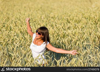 Happy young woman in corn field enjoy sunset on sunny day