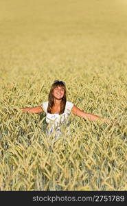 Happy young woman in corn field enjoy sunset on sunny day