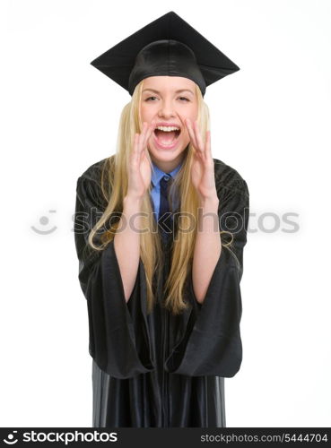 Happy young woman in graduation gown shouting through megaphone